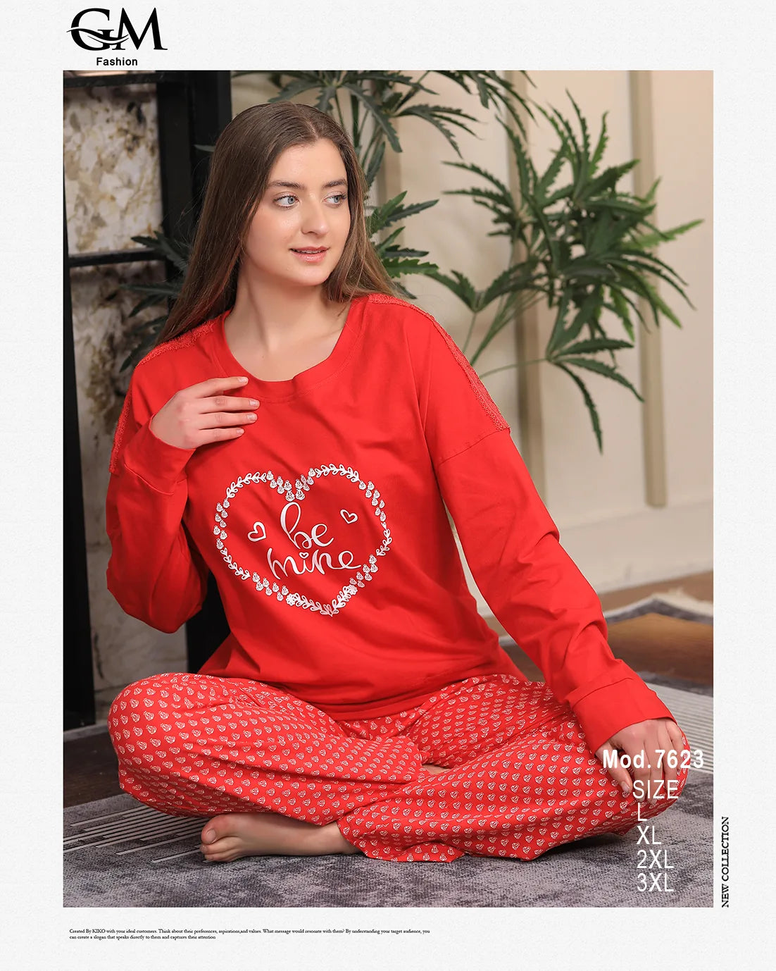 Woman wearing a red outfit with a heart design, sitting indoors.