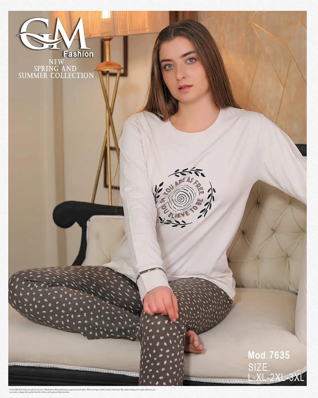 Woman sitting on a couch wearing a white long-sleeve shirt with a design and gray pants with white patterns, with 'G&M Fashion' branding.