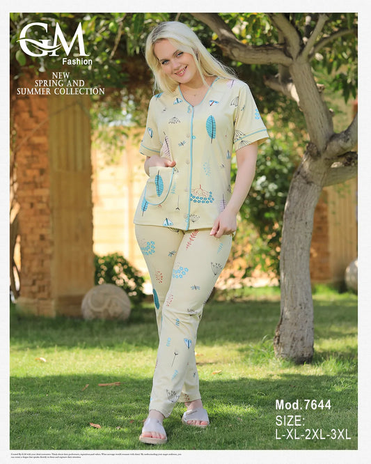 Woman wearing a matching outfit with floral patterns in a garden setting, featuring GM Fashion branding.