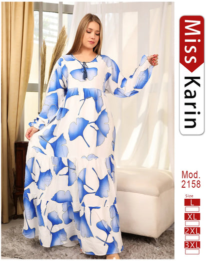 Woman wearing a blue and white floral dress with 'Miss Karin' branding.