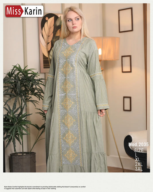 Woman wearing a green embroidered dress in a room with decor elements.