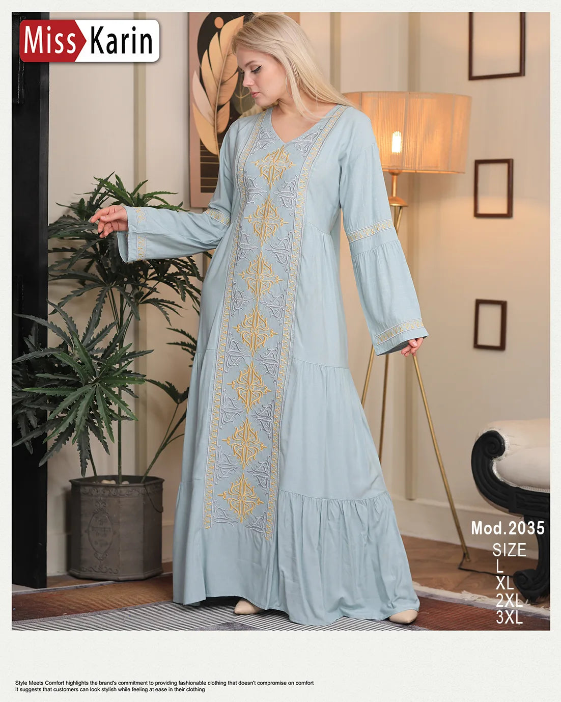 Woman wearing a light blue dress with gold embroidery in a room setting, featuring 'Miss Karin' branding.