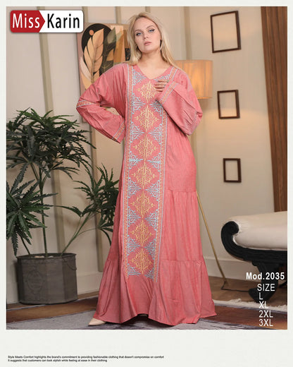 Woman wearing a pink dress with intricate patterns in a room setting, featuring 'Miss Karin' branding.