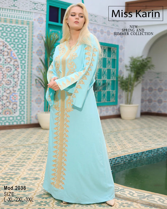 Woman wearing a light blue dress with gold embroidery in a decorative setting.