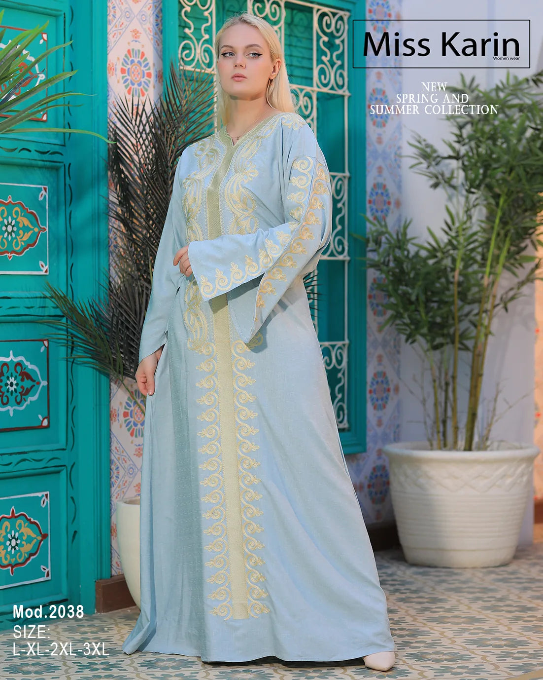 Woman wearing a light blue dress with embroidery in a decorative setting, featuring 'Miss Karin' branding.