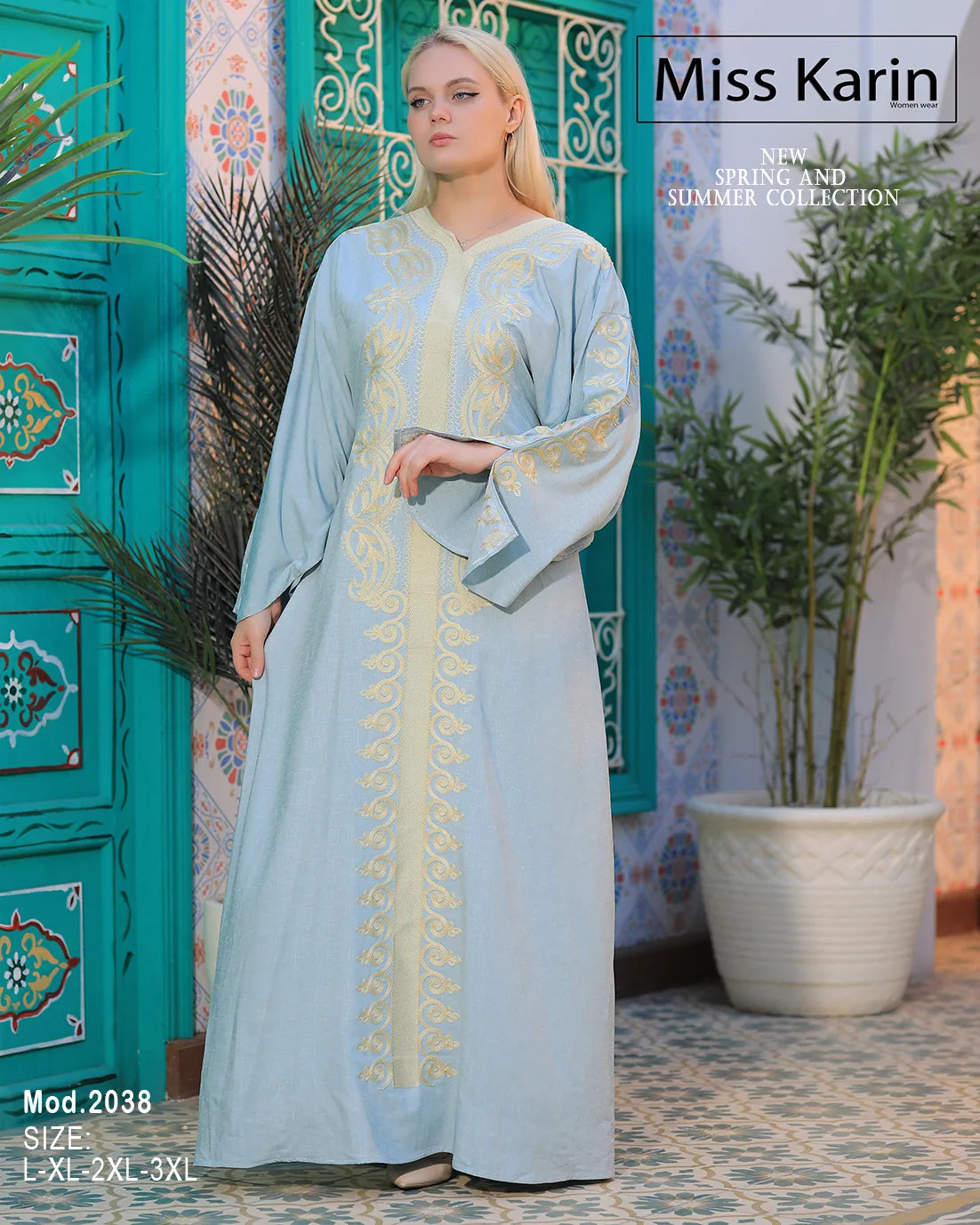 Woman wearing a light blue dress with gold embroidery in a decorative setting, featuring 'Miss Karin' branding.