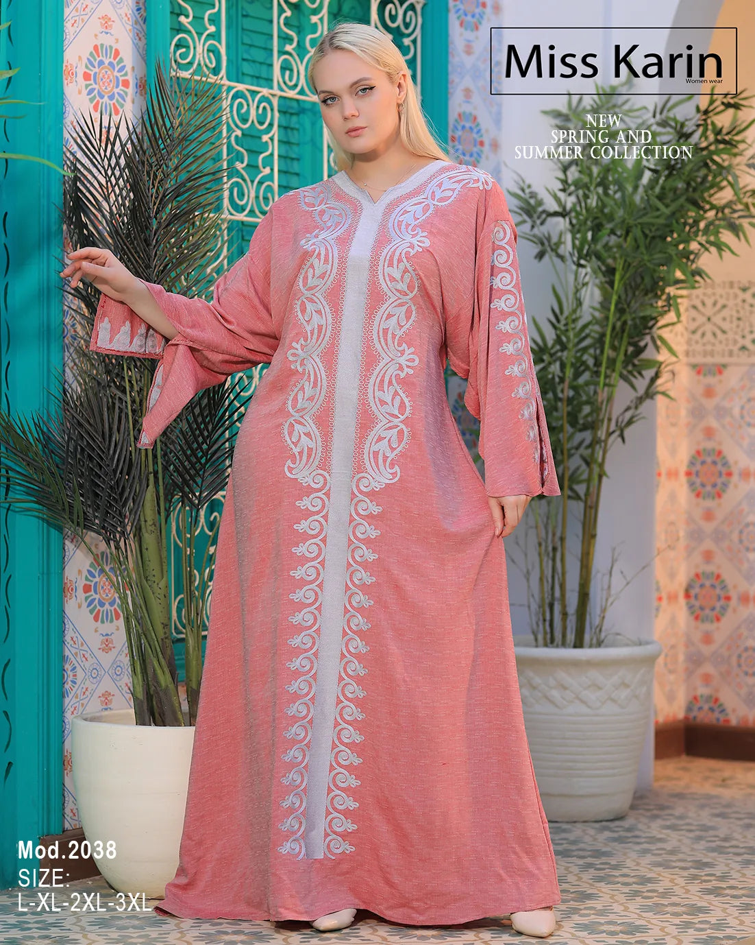 Woman wearing a pink embroidered dress with a decorative background, featuring the brand 'Miss Karin'.