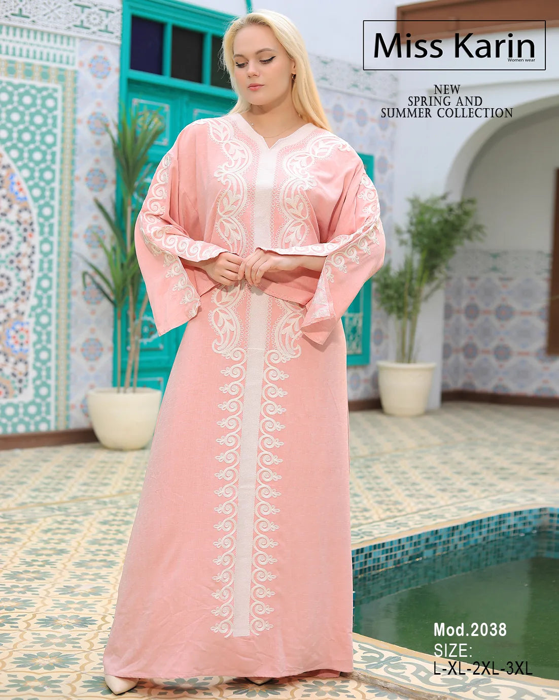 Woman wearing a pink embroidered dress in a decorative indoor setting with 'Miss Karin' branding.