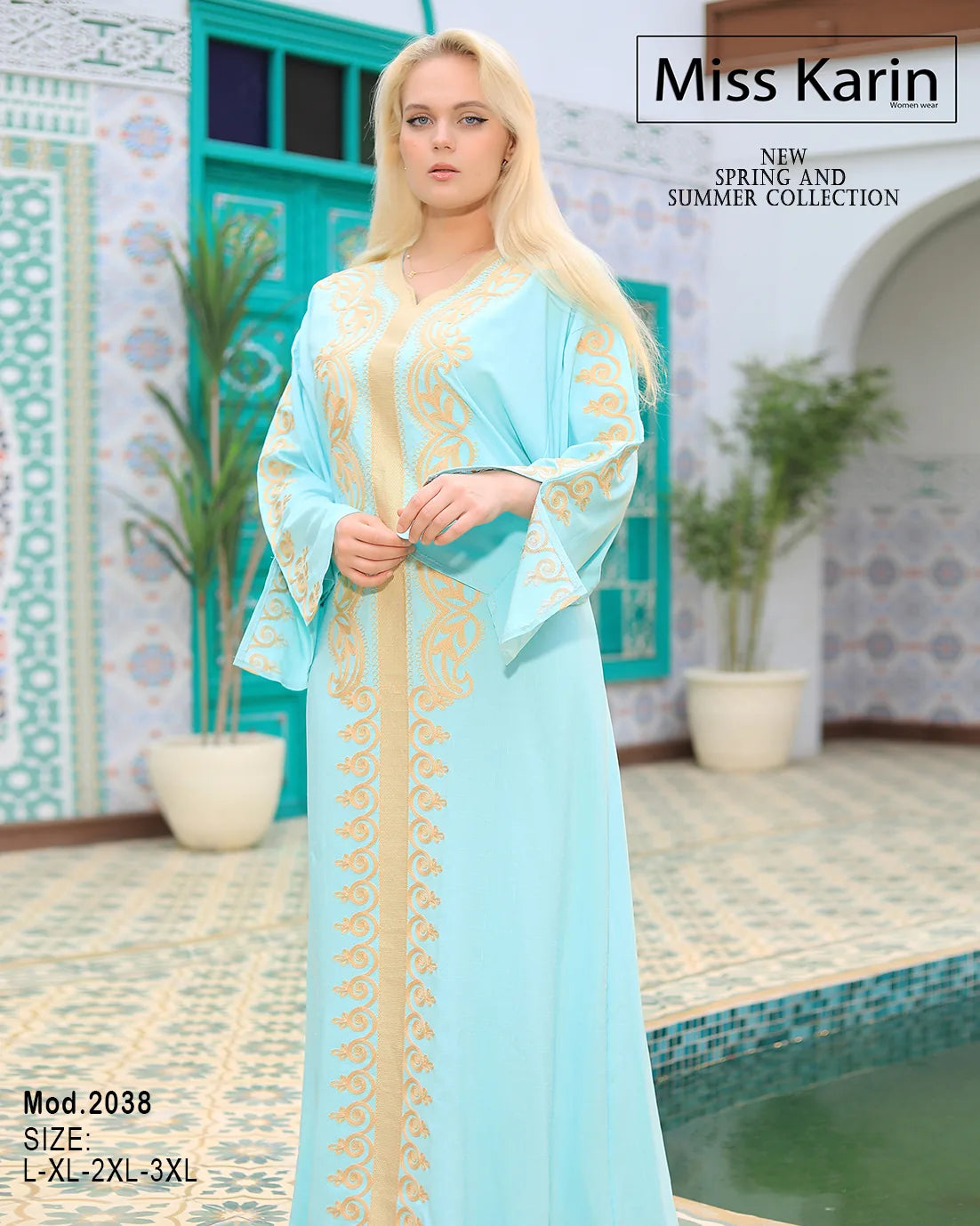 Woman wearing a light blue dress with gold patterns in an outdoor setting, with 'Miss Karin' branding.