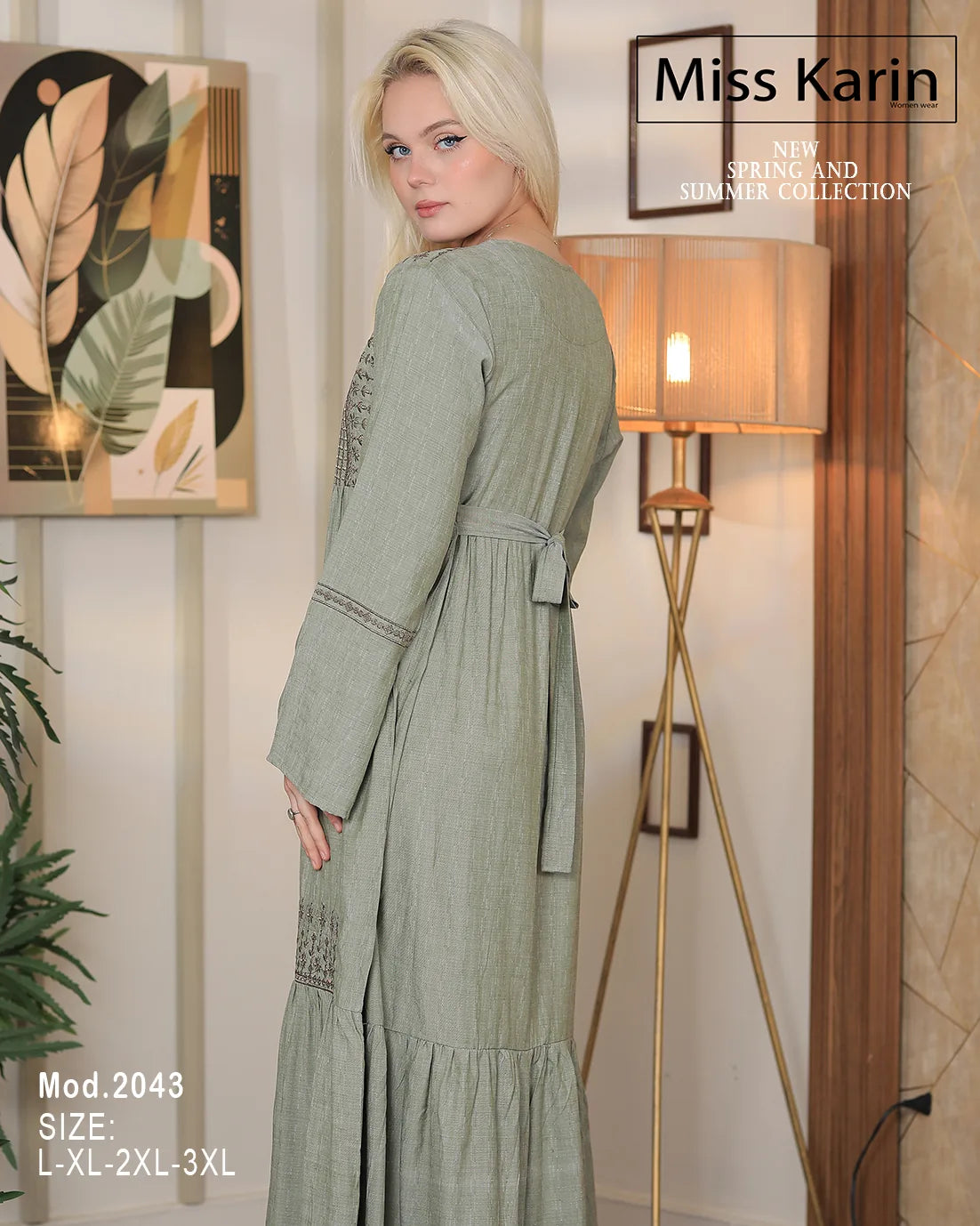 Woman wearing a green dress with 'Miss Karin' branding in an indoor setting.