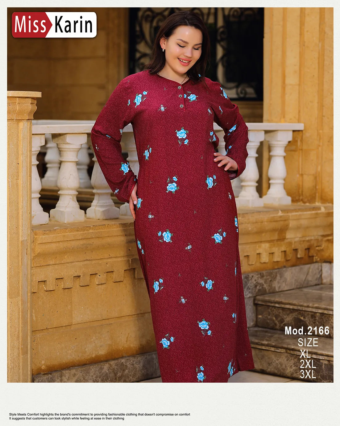 Woman wearing a red dress with blue floral patterns in an outdoor setting.