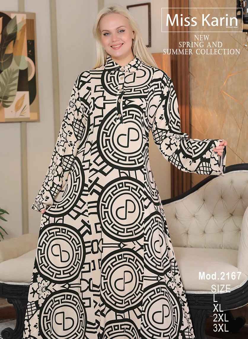 Woman wearing a black and white patterned dress with 'Miss Karin' branding in a room.