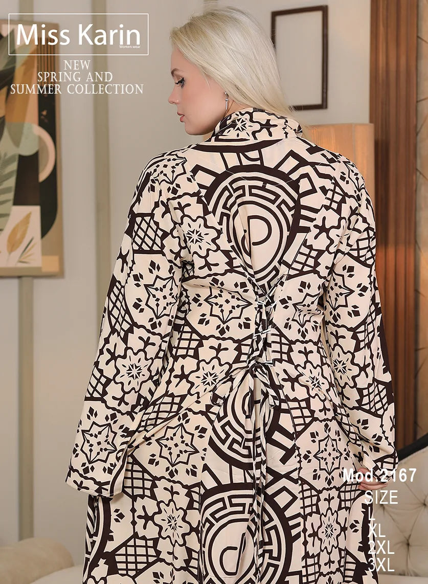 Woman wearing a black and white patterned dress with 'Miss Karin' branding.