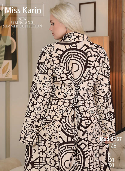 Woman wearing a black and white patterned dress with 'Miss Karin' branding.