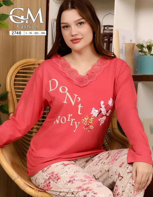 Woman wearing a red pajama set with 'Don't worry' text, sitting on a chair indoors.