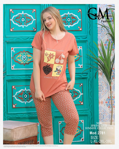 Woman wearing a peach-colored t-shirt and patterned leggings against a decorative teal wall.