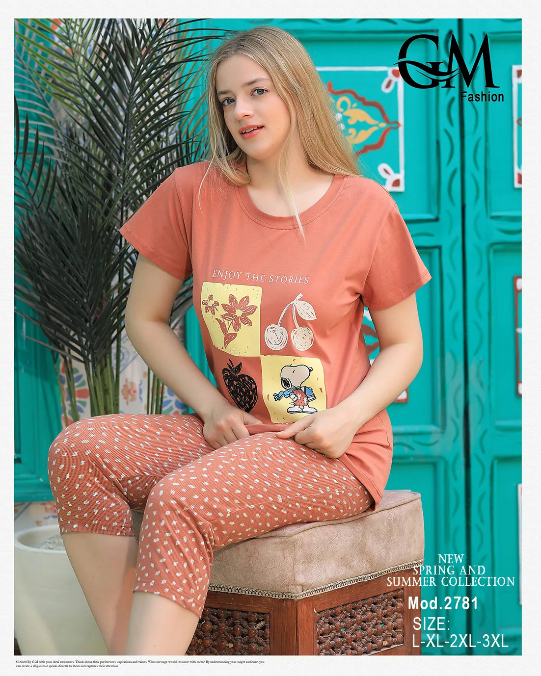 Woman wearing a matching outfit with a colorful design, sitting on a chair against a teal wall.