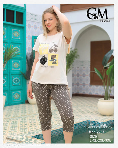 Woman wearing a white t-shirt with a graphic design and patterned leggings outdoors.