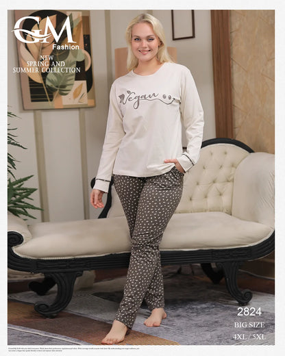 Woman wearing pink 'Vegan' top and patterned pants in a room with a couch.