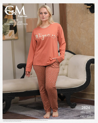 Woman wearing pink 'Vegan' top and patterned pants in a room with a couch.