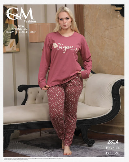 Woman wearing pink 'Vegan' top and patterned pants in a room with a couch.