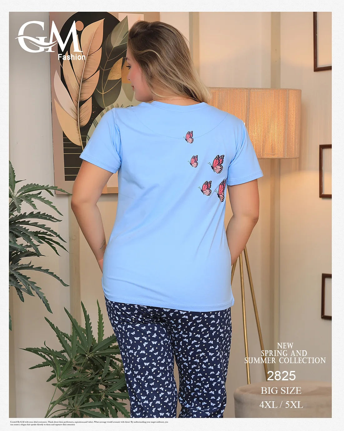 Woman wearing a light blue t-shirt with butterfly designs and dark blue patterned pants in a room setting.