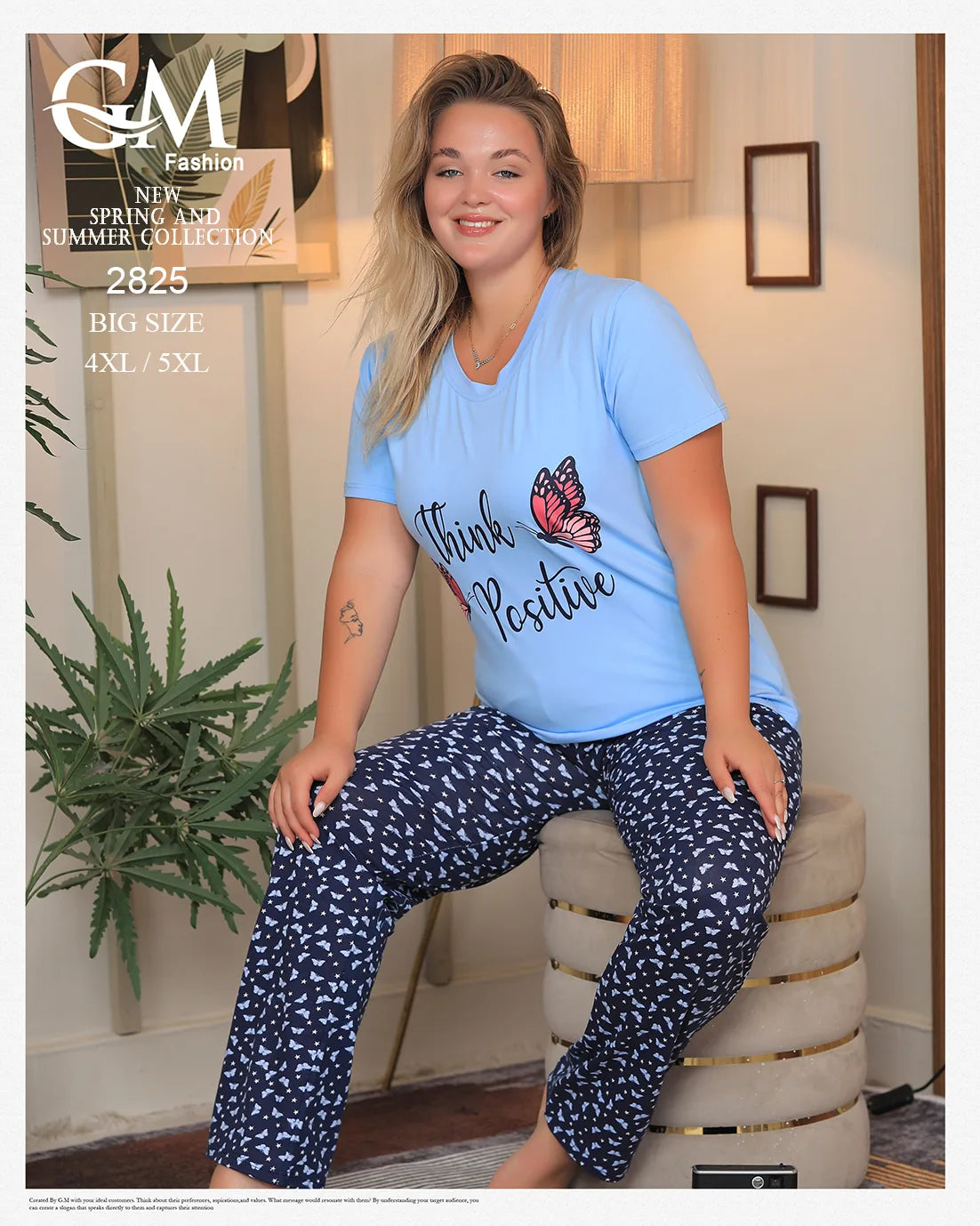 Woman wearing a blue 'Think Positive' t-shirt and navy patterned pants sitting on a chair.