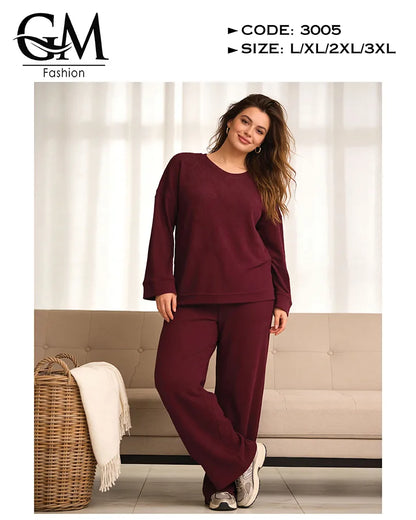 Woman wearing a burgundy outfit with 'GM Fashion' branding in a living room setting.