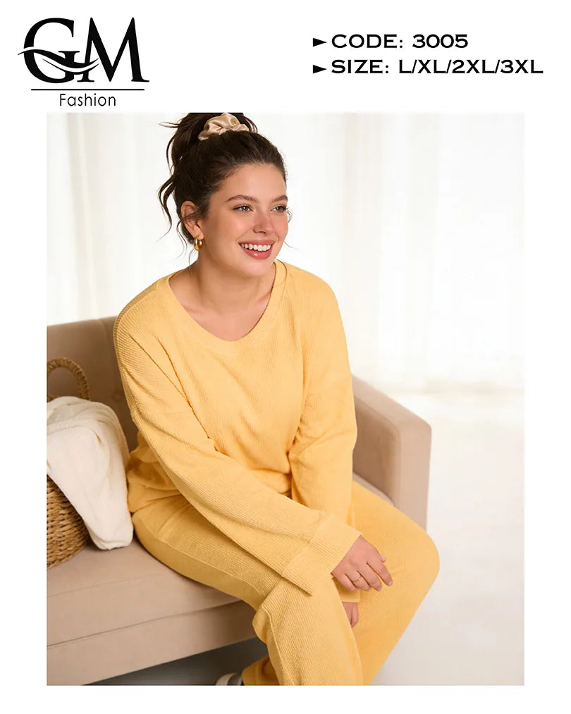 Woman wearing a yellow outfit sitting on a couch with 'GM Fashion' branding.