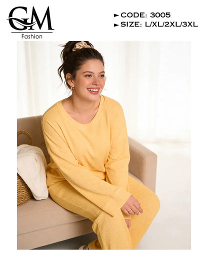 Woman wearing a yellow outfit sitting on a couch with 'GM Fashion' branding.