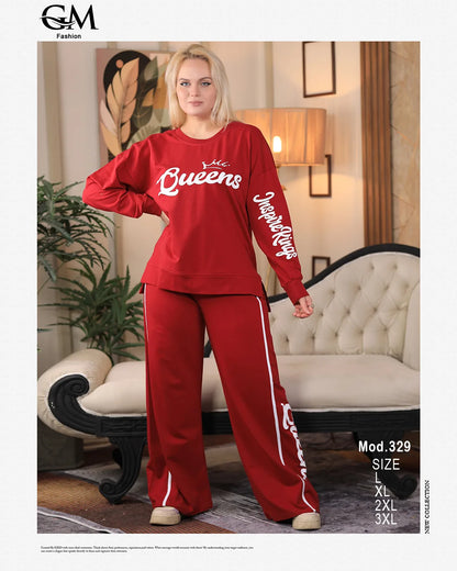 Woman wearing a red 'Queens' tracksuit in a living room setting