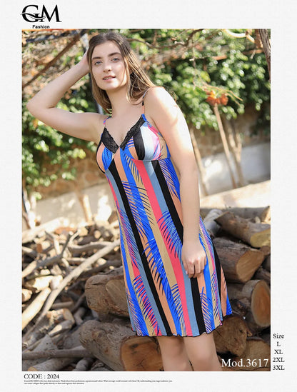 Woman wearing a colorful striped dress standing outdoors with logs and greenery in the background.