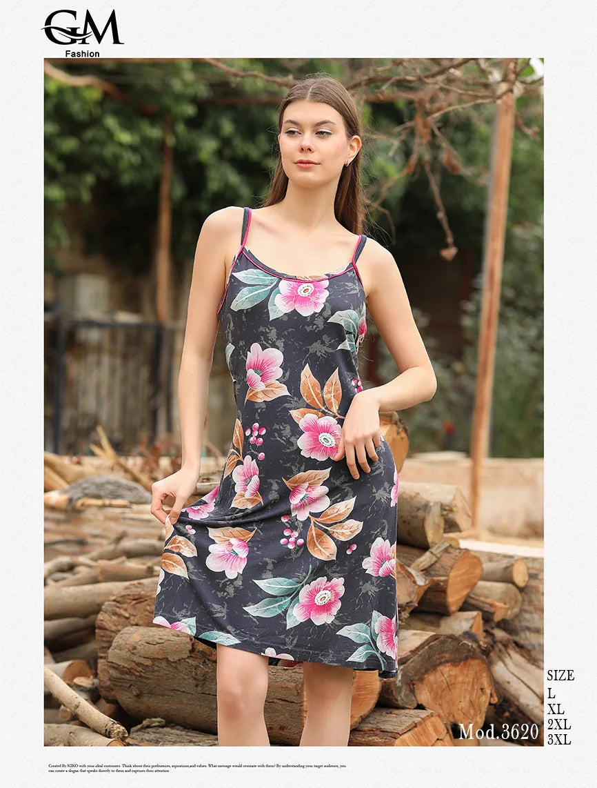Woman wearing a floral dress standing among logs with 'G&M Fashion' branding.