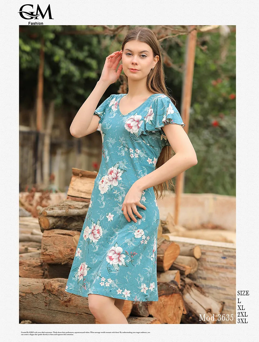 Woman wearing a floral dress standing outdoors with logs in the background