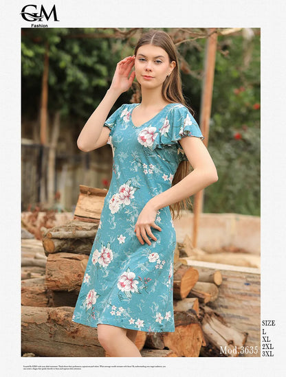 Woman wearing a floral dress standing outdoors with logs in the background