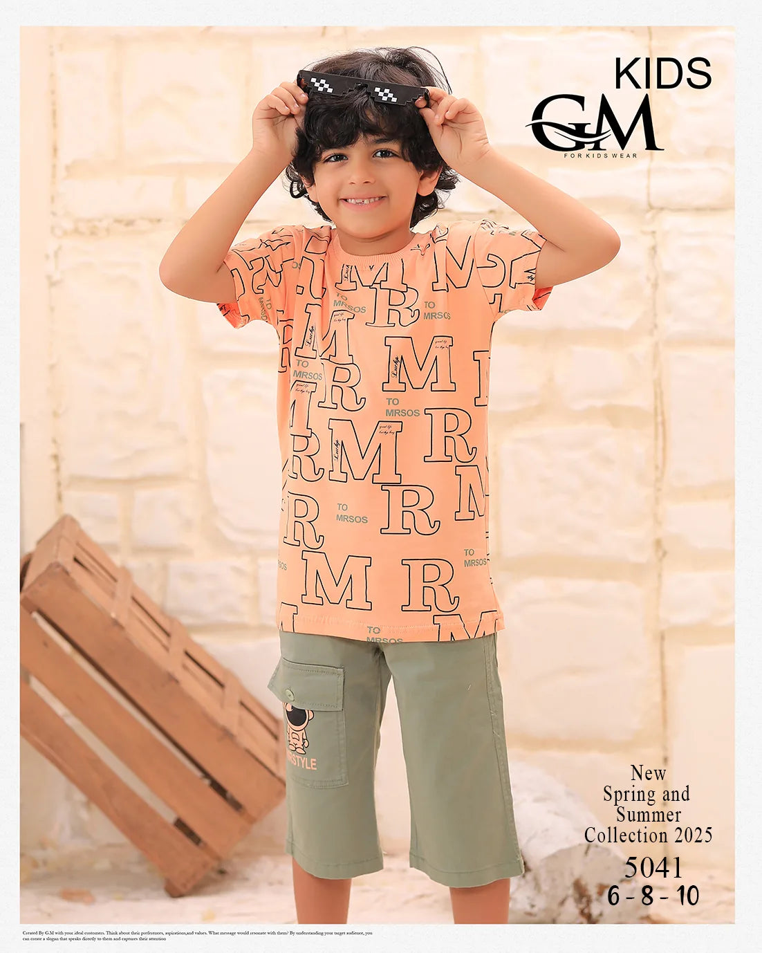 Child wearing a patterned shirt and shorts with 'GM' branding on a light background