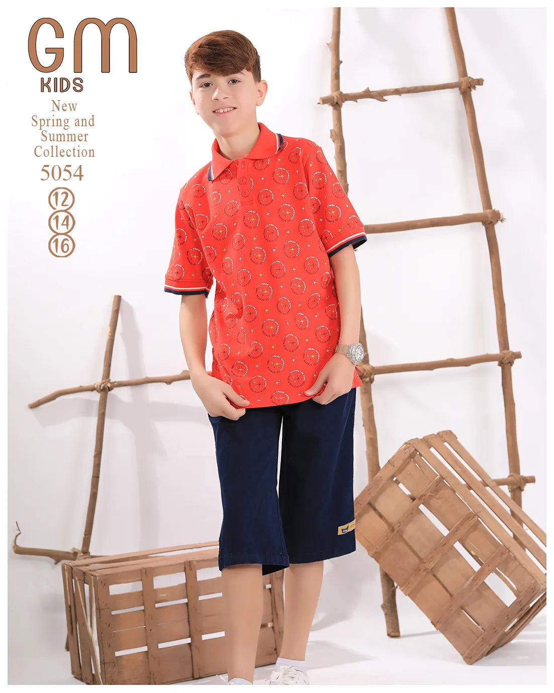 Child wearing a red patterned shirt and navy shorts standing in front of wooden ladders and crates.