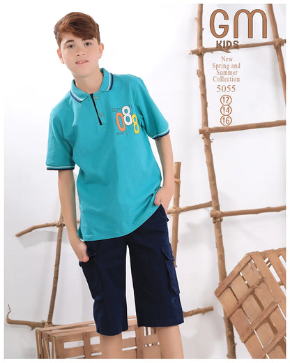 Child wearing a teal polo shirt with a logo and navy shorts, standing against a white background with wooden decor.