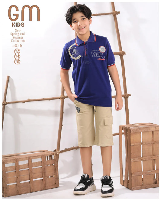 Child wearing a blue polo shirt and beige shorts with a wooden ladder background
