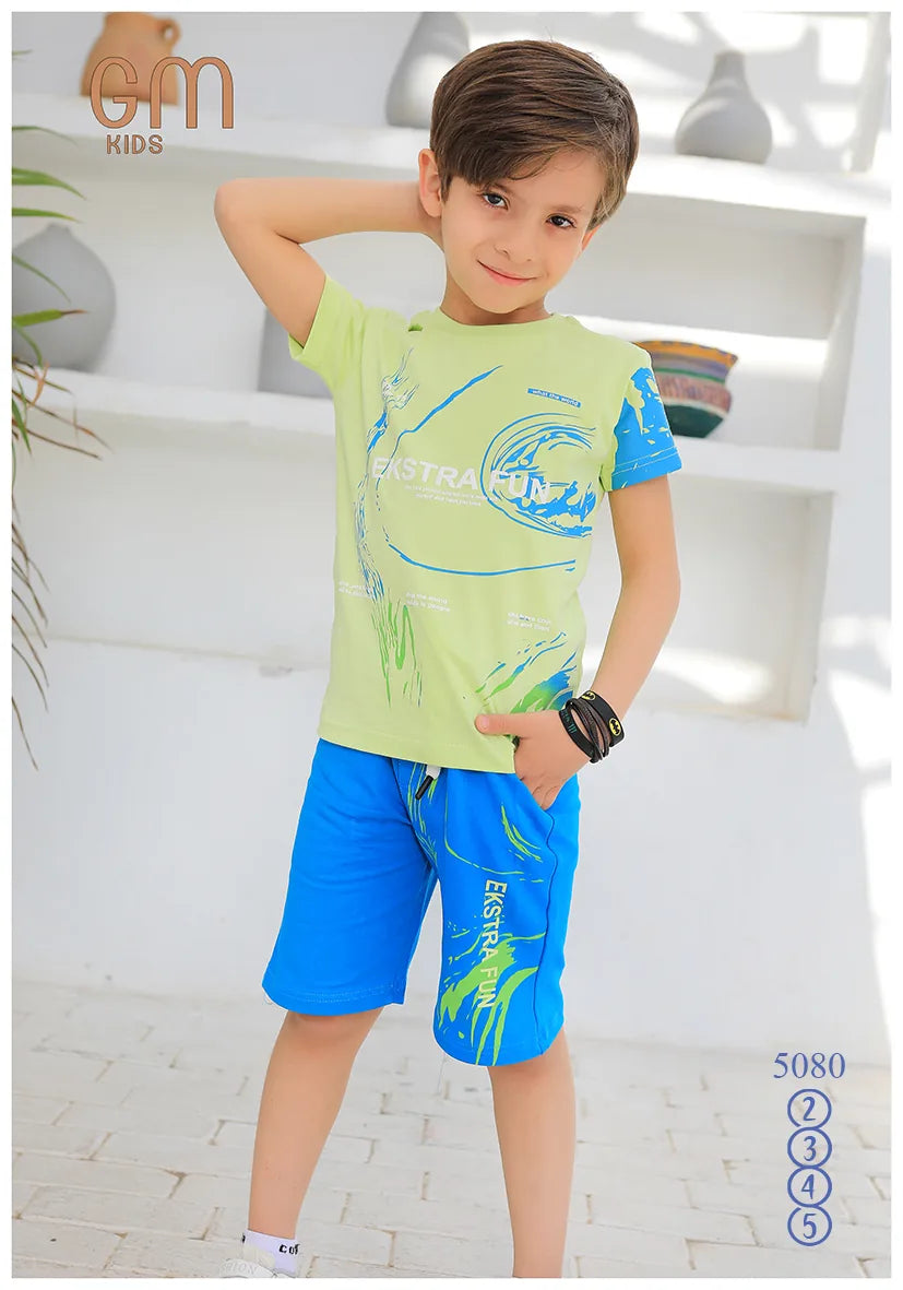 Child wearing a green t-shirt and blue shorts with a brand logo in the corner.