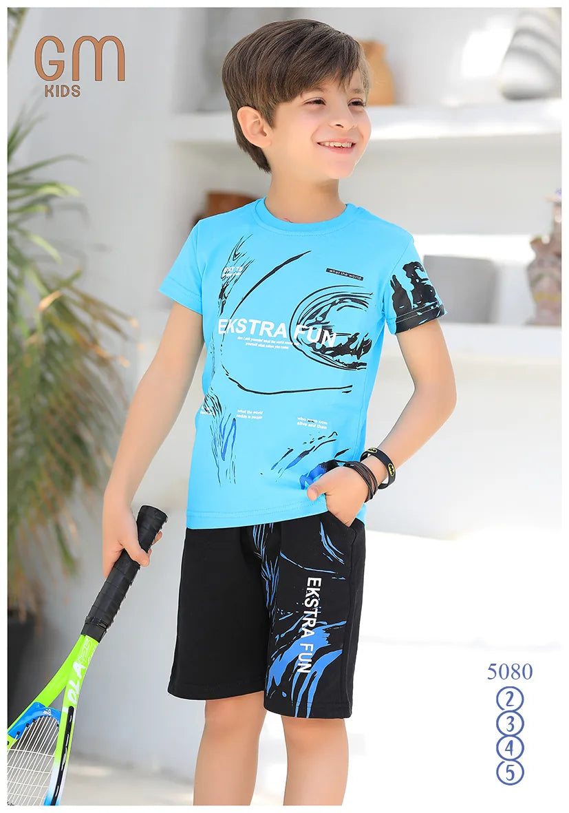 Child wearing a blue t-shirt and black shorts with graphic designs, holding a tennis racket indoors.