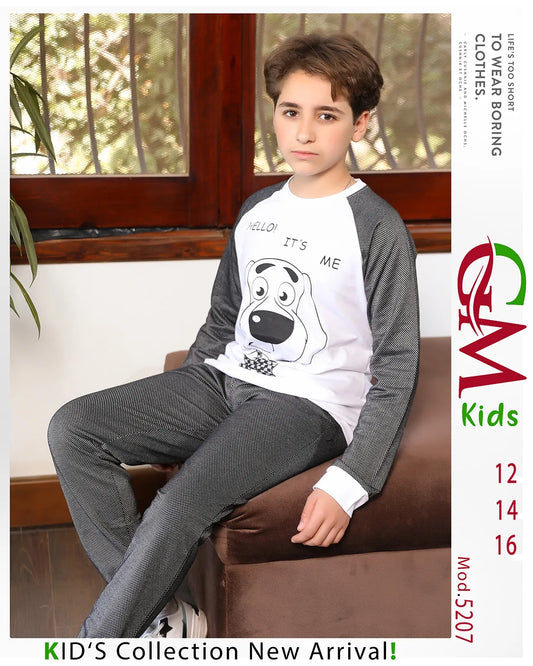 Child wearing a gray and white outfit with a dog graphic, sitting on a couch.