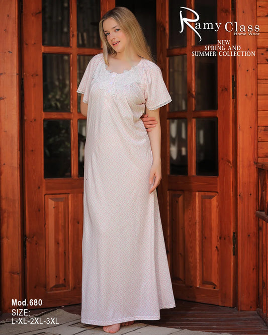 Woman wearing a long, light-colored dress with a wooden door background