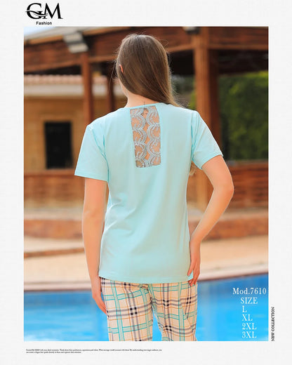 Woman wearing a light blue top with a patterned back and plaid pants by a pool, with 'GM Fashion' branding.