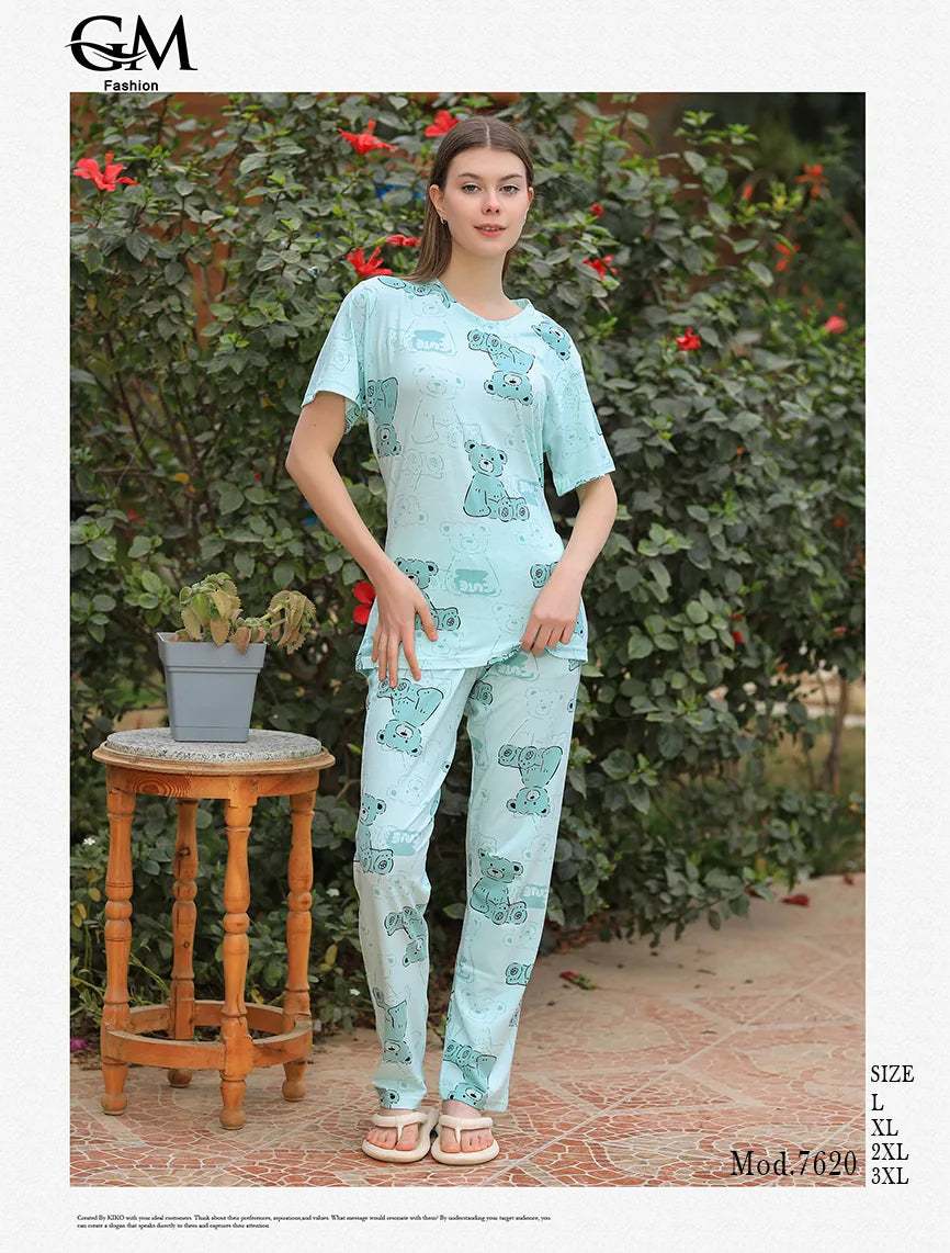 Woman wearing a light blue pajama set with a floral pattern in an outdoor setting.