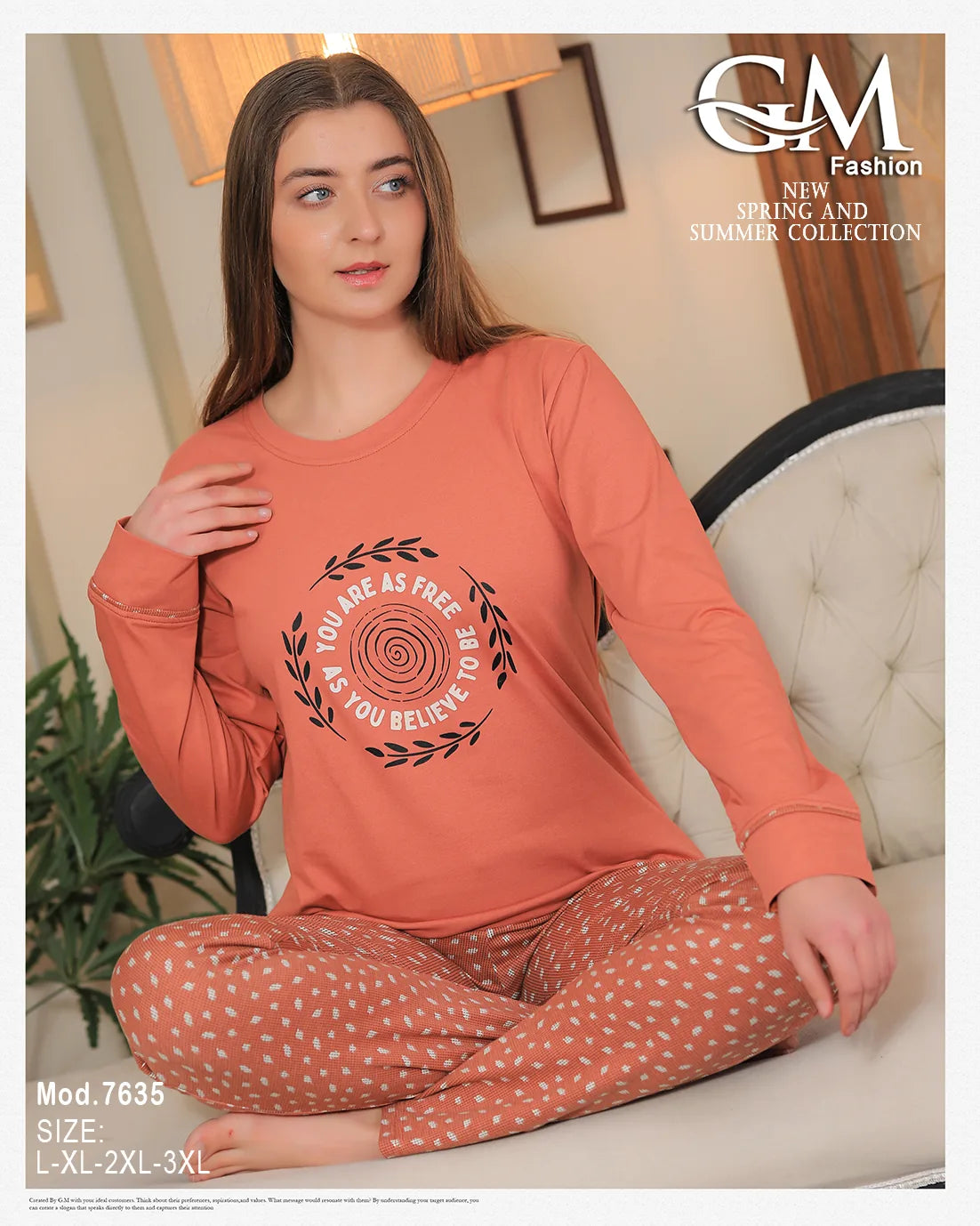 Woman wearing a coral long-sleeve top and patterned pants sitting on a chair.