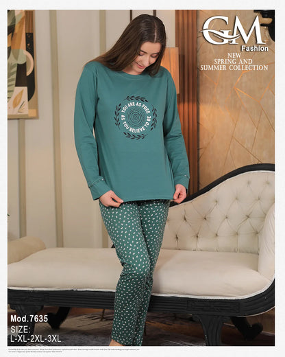 Woman wearing a teal long-sleeve top and patterned pants sitting on a couch, with 'GM Fashion' branding.