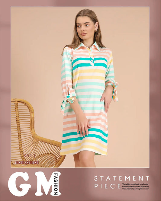 Woman wearing a colorful striped dress with a chair in the background, featuring the brand 'GM Fashion'.